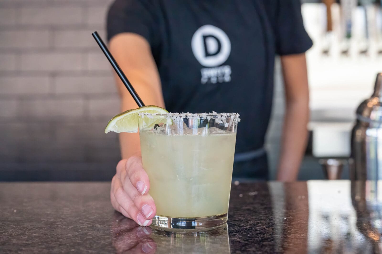 Margarita cocktail with salt on rim and lime