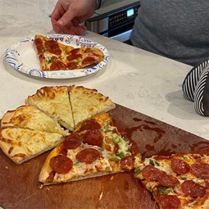 pizzas sliced on a cutting board.