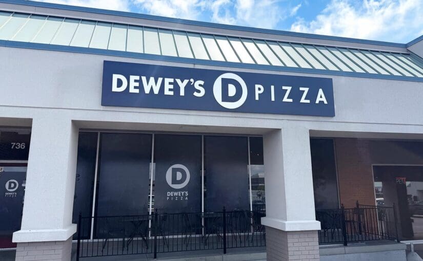 Exterior storefront of Dewey's Pizza in Creve Coeur with branded signage above large front windows.